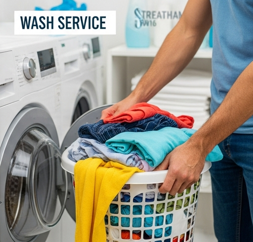 Customer loading colorful laundry basket at The Big Wash self-service laundromat in South Lambeth, featuring modern commercial washing machines